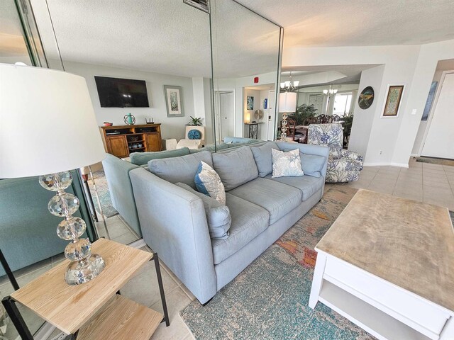 9650 Shore Dr Unit 1203, Myrtle Beach, SC 29572 - living area featuring a chandelier, tile patterned flooring, and a textured ceiling