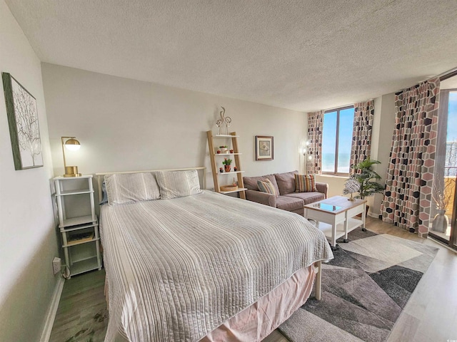 9650 Shore Dr Unit 1203, Myrtle Beach, SC 29572 - bedroom featuring wood finished floors, baseboards, and a textured ceiling