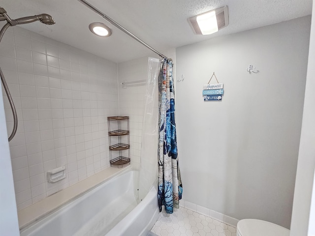 9650 Shore Dr Unit 1203, Myrtle Beach, SC 29572 - bathroom featuring shower / bath combo with shower curtain, tile patterned floors, toilet, baseboards, and a textured ceiling