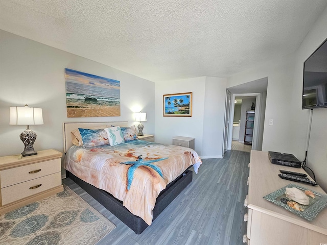 9650 Shore Dr Unit 1203, Myrtle Beach, SC 29572 - bedroom with wood finished floors, baseboards, and a textured ceiling