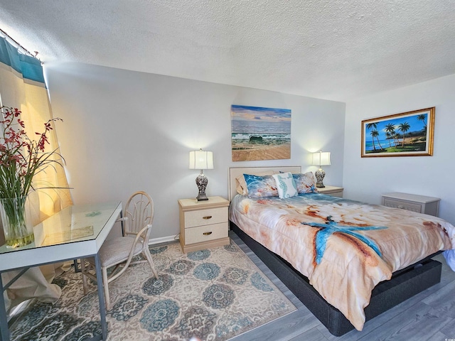 9650 Shore Dr Unit 1203, Myrtle Beach, SC 29572 - bedroom featuring a textured ceiling, baseboards, and wood finished floors