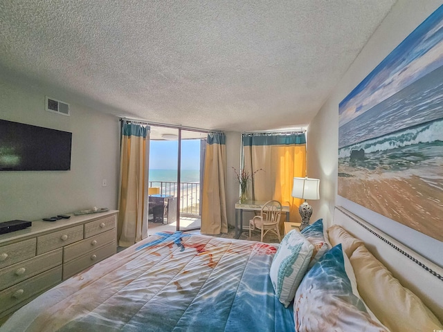 9650 Shore Dr Unit 1203, Myrtle Beach, SC 29572 - bedroom with access to exterior, floor to ceiling windows, a textured ceiling, and a water view