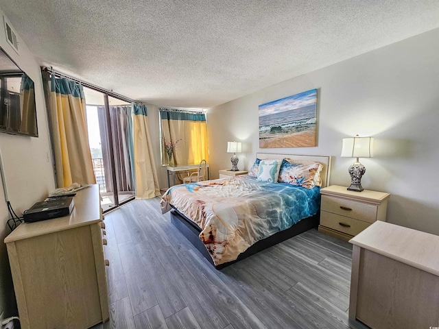 9650 Shore Dr Unit 1203, Myrtle Beach, SC 29572 - bedroom with wood finished floors, a wall of windows, and a textured ceiling