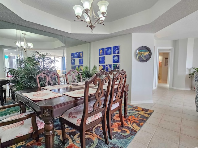 9650 Shore Dr Unit 1203, Myrtle Beach, SC 29572 - dining area featuring a chandelier, light tile patterned floors, a tray ceiling, and baseboards