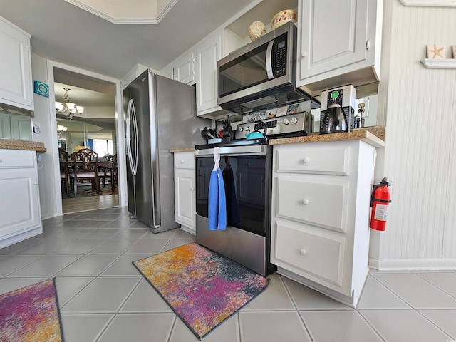 9650 Shore Dr Unit 1203, Myrtle Beach, SC 29572 - kitchen featuring stainless steel appliances, white cabinetry, a chandelier, and light tile patterned floors