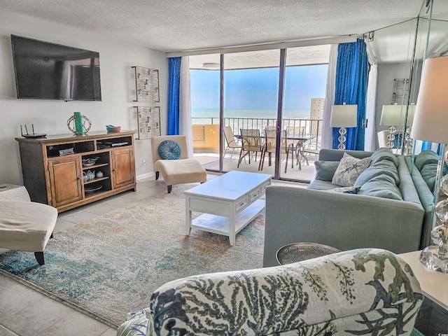 9650 Shore Dr Unit 1203, Myrtle Beach, SC 29572 - living room with a wall of windows, a textured ceiling, light tile patterned floors, and a water view