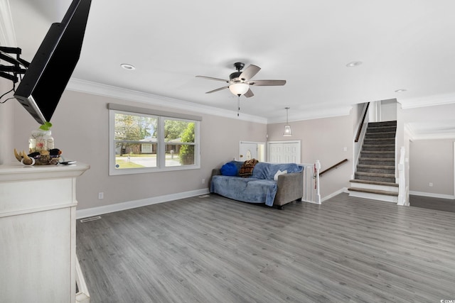 1720 Horry St, Conway, SC 29526 - living room featuring a ceiling fan, wood finished floors, baseboards, stairway, and ornamental molding