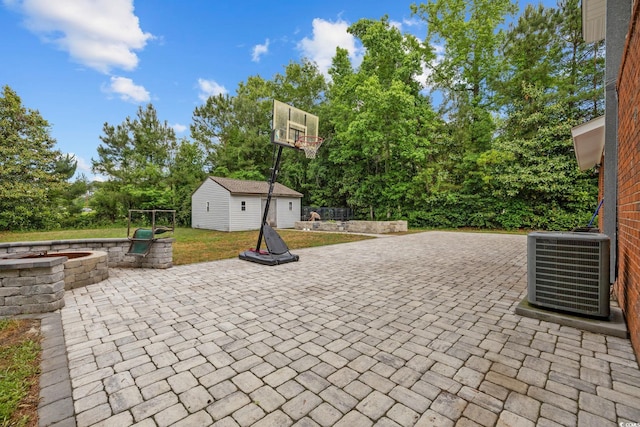1720 Horry St, Conway, SC 29526 - view of patio with a fire pit, cooling unit, an outdoor structure, and view of wooded area