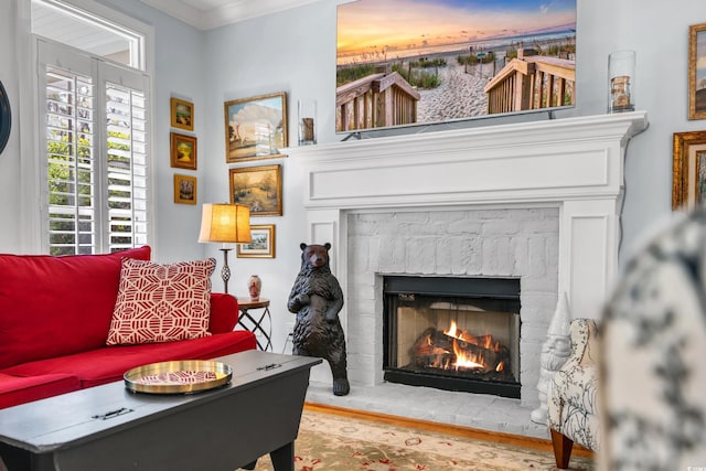 living room with a fireplace, wood finished floors, and ornamental molding