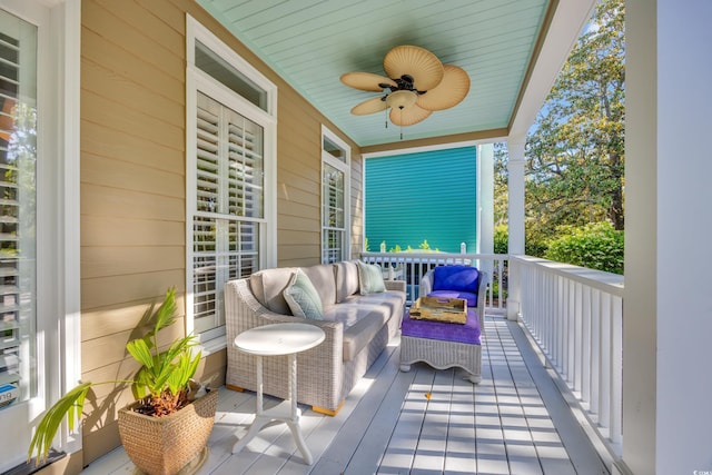 balcony with outdoor lounge area and a ceiling fan