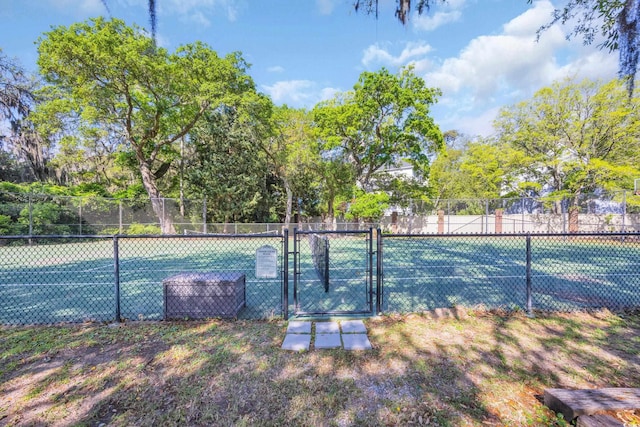 view of tennis court featuring a gate and fence