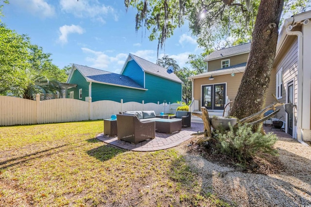 rear view of house with outdoor lounge area, french doors, and a patio