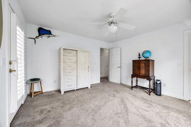 carpeted bedroom featuring baseboards and a ceiling fan