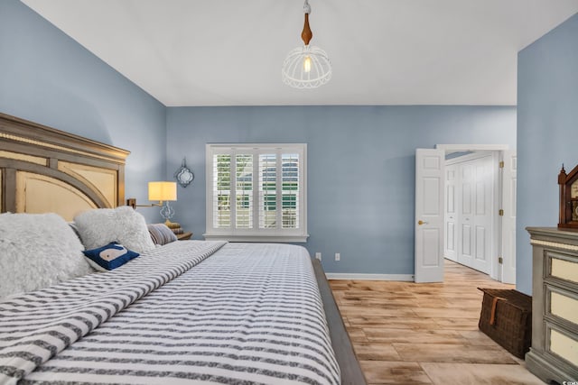 bedroom featuring wood finished floors and baseboards