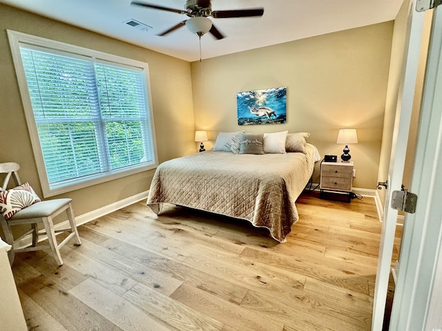 bedroom with wood finished floors, baseboards, and ceiling fan