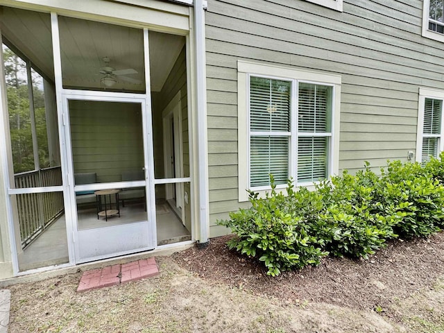 entrance to property featuring ceiling fan
