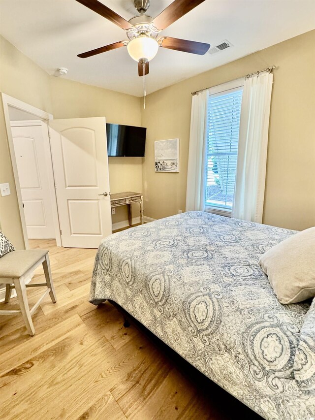bedroom with light wood-style flooring and ceiling fan
