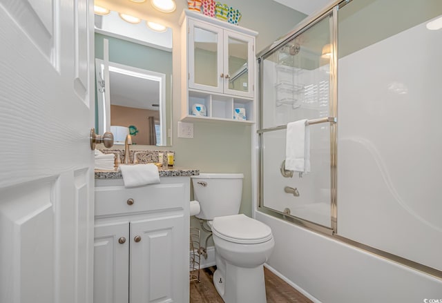6001-8026 S Kings Hwy, Myrtle Beach, SC 29575 - bathroom featuring enclosed tub / shower combo, vanity, toilet, and wood finished floors