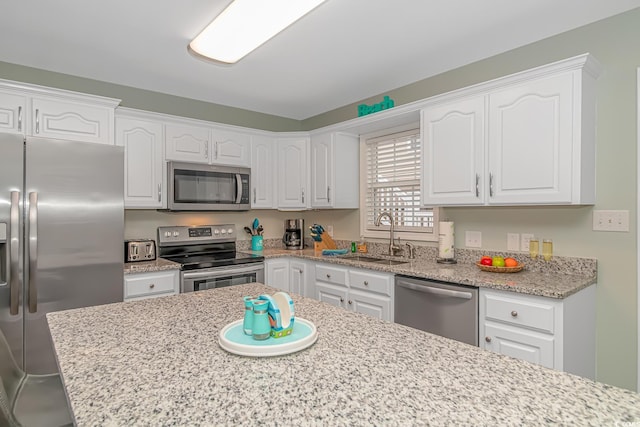 6001-8026 S Kings Hwy, Myrtle Beach, SC 29575 - kitchen with appliances with stainless steel finishes, a sink, white cabinets, and light stone countertops