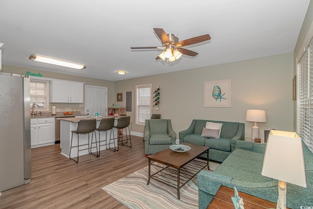6001-8026 S Kings Hwy, Myrtle Beach, SC 29575 - living room featuring a ceiling fan, light wood finished floors, and baseboards