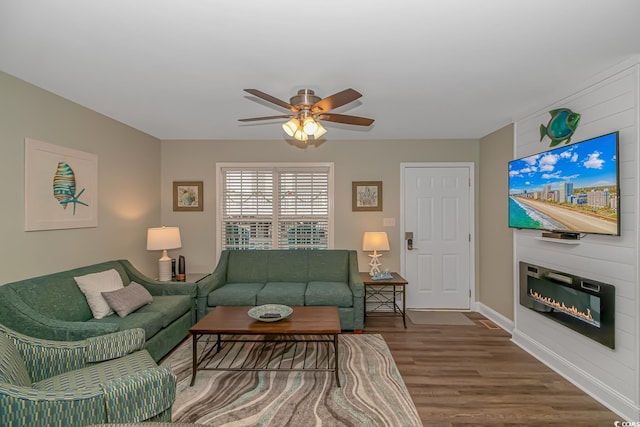 6001-8026 S Kings Hwy, Myrtle Beach, SC 29575 - living room with wood finished floors, ceiling fan, a large fireplace, and baseboards