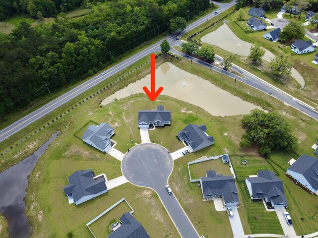 aerial view of property's location with a forest and nearby suburban area
