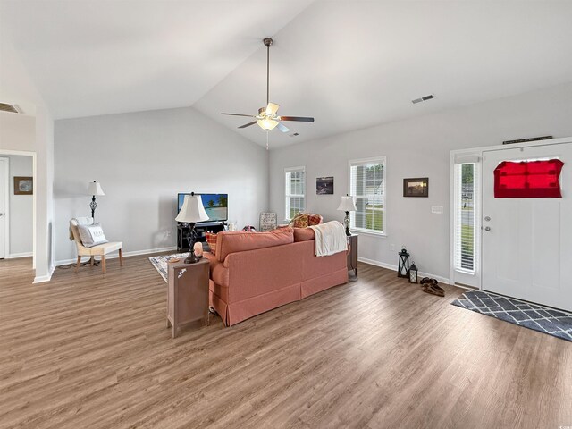 kitchen featuring stainless steel appliances, a sink, light wood-style flooring, tasteful backsplash, and white cabinetry