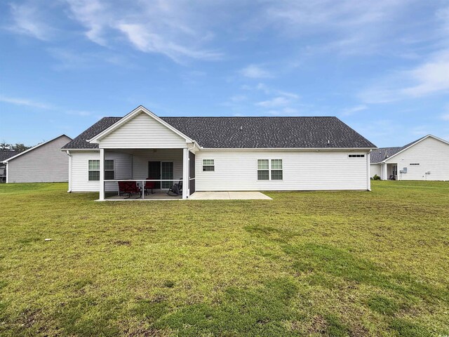 rear view of house with a patio, central AC unit, a yard, and a shingled roof
