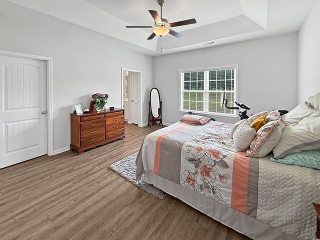bathroom featuring wood finished floors, baseboards, and double vanity