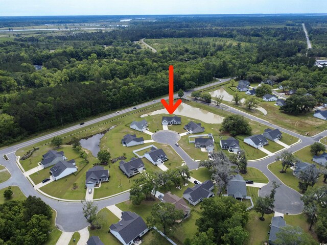 view of property location featuring a forest