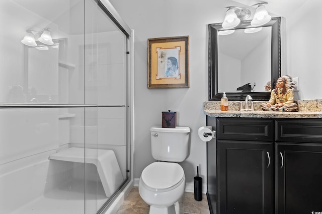 full bathroom with a shower stall, toilet, vanity, and baseboards