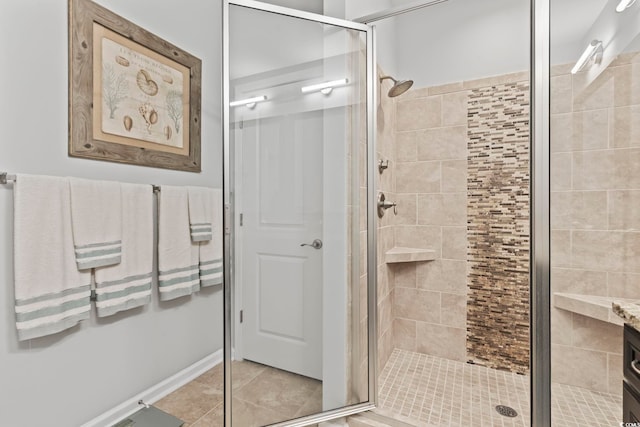bathroom with a stall shower and tile patterned flooring