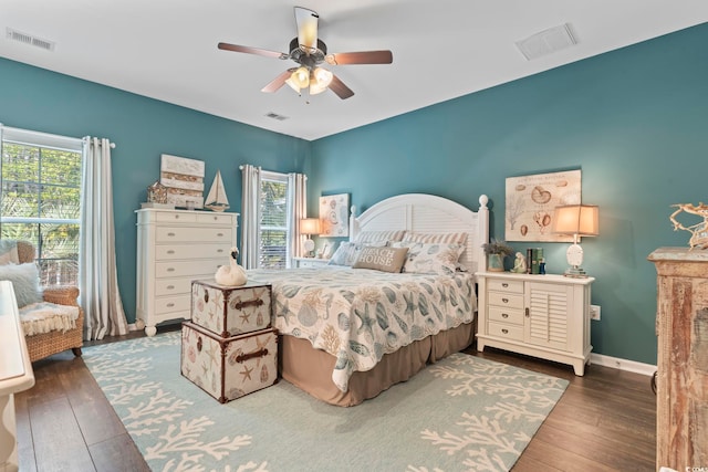 bedroom with hardwood / wood-style floors, multiple windows, and a ceiling fan