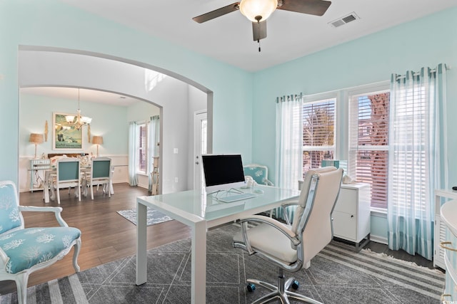 office featuring arched walkways, a ceiling fan, a chandelier, and wood finished floors