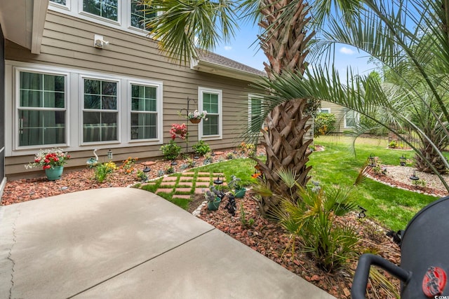 view of exterior entry with a patio and a yard