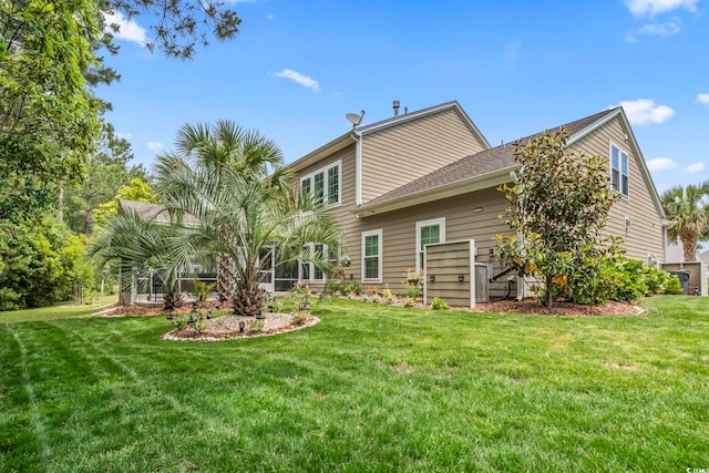 back of house with a lawn