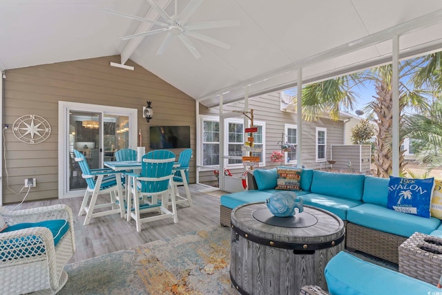 sunroom / solarium featuring an outdoor living space, a ceiling fan, and outdoor dining area