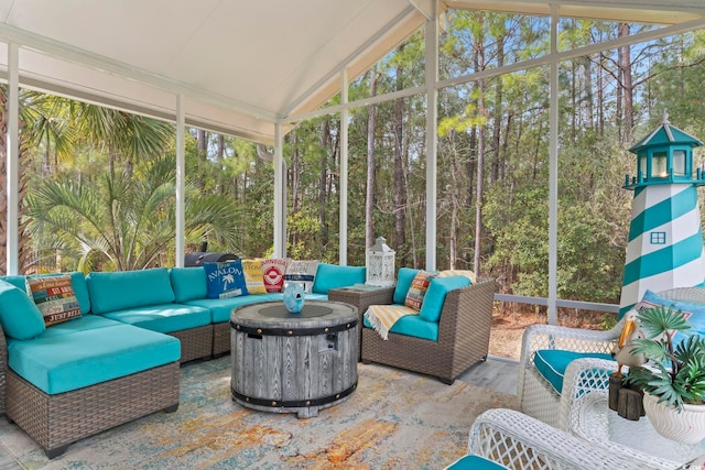 sunroom with an outdoor living space and vaulted ceiling