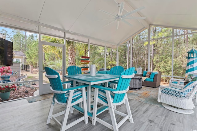 sunroom / solarium with ceiling fan, outdoor lounge area, lofted ceiling, and outdoor dining area