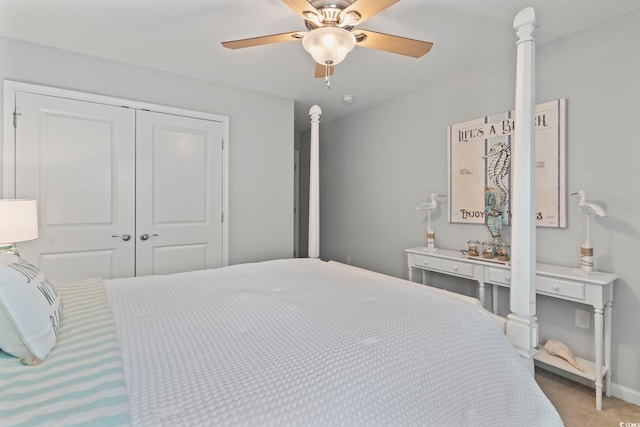 carpeted bedroom with a closet, a ceiling fan, and baseboards