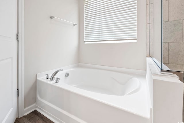 full bathroom with a bath