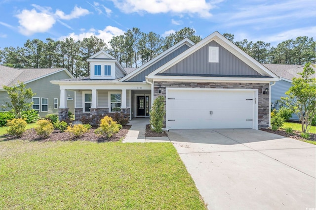 craftsman inspired home featuring stone siding, board and batten siding, an attached garage, and a front lawn