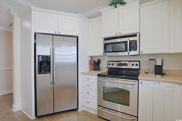 719 Shearwater Ct Unit 301, Murrells Inlet, SC 29576 - kitchen with stainless steel appliances, ornamental molding, light tile patterned floors, white cabinetry, and light countertops