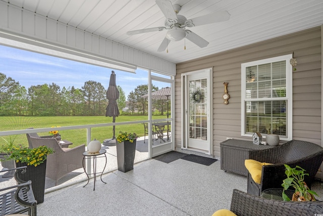 sunroom featuring ceiling fan