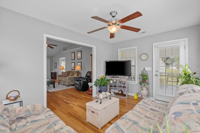 living room with a ceiling fan, light wood-style floors, and baseboards