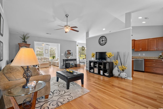 living room with ceiling fan, lofted ceiling, light wood-style floors, and recessed lighting