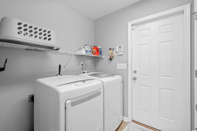 laundry area with independent washer and dryer