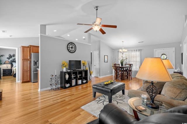 living area with vaulted ceiling, ceiling fan, baseboards, light wood finished floors, and a chandelier