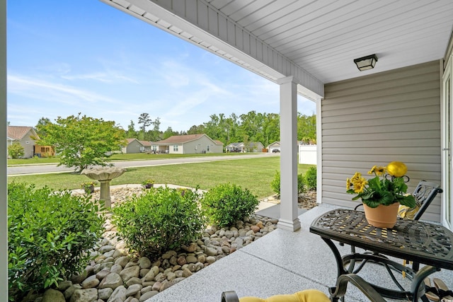 view of patio featuring a porch and a residential view