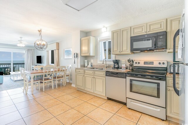 1011 S Ocean Blvd, Surfside Beach, SC 29575 - kitchen with cream cabinets, appliances with stainless steel finishes, light tile patterned floors, and a sink